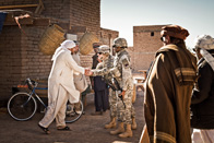soldiers meeting with Afghan men